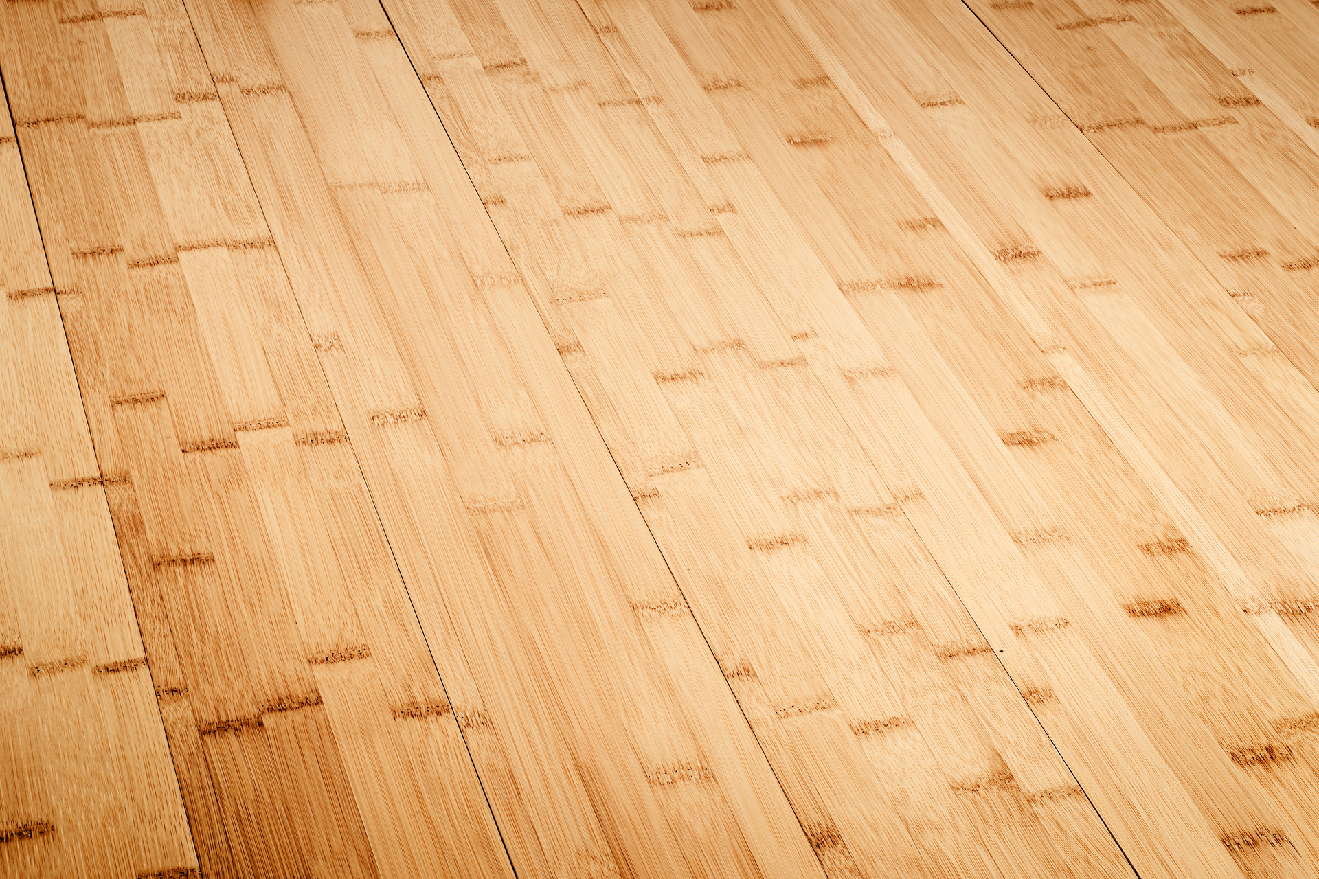 Close-up of a bamboo wooden floor showcasing its natural grain and pattern with a smooth, polished finish, reflecting sustainable practices in modern flooring design.